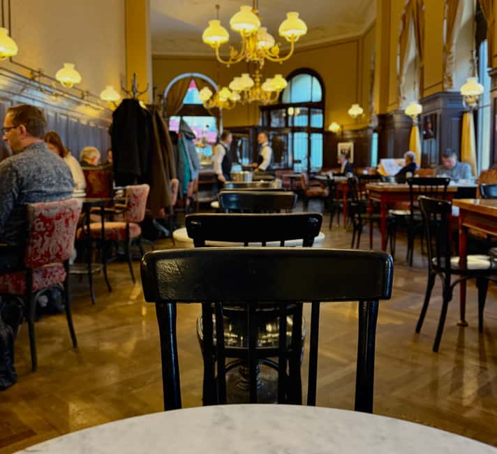 Vienna: Guided Food Tour with 8+ Food Tasting & Secret Dish - Kasëkrainer at a local stall, including the famous Anthony Bourdain link